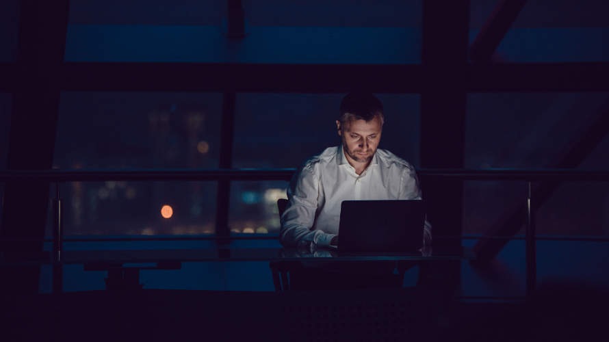 businessman-working-on-laptop-in-night-office